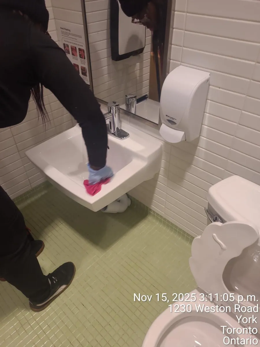 AAFM janitorial staff cleaning a commercial washroom sink