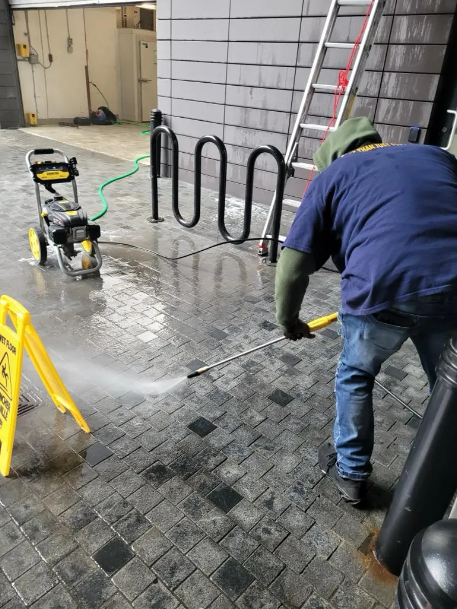 AAFM technician pressure washing a commercial exterior walkway